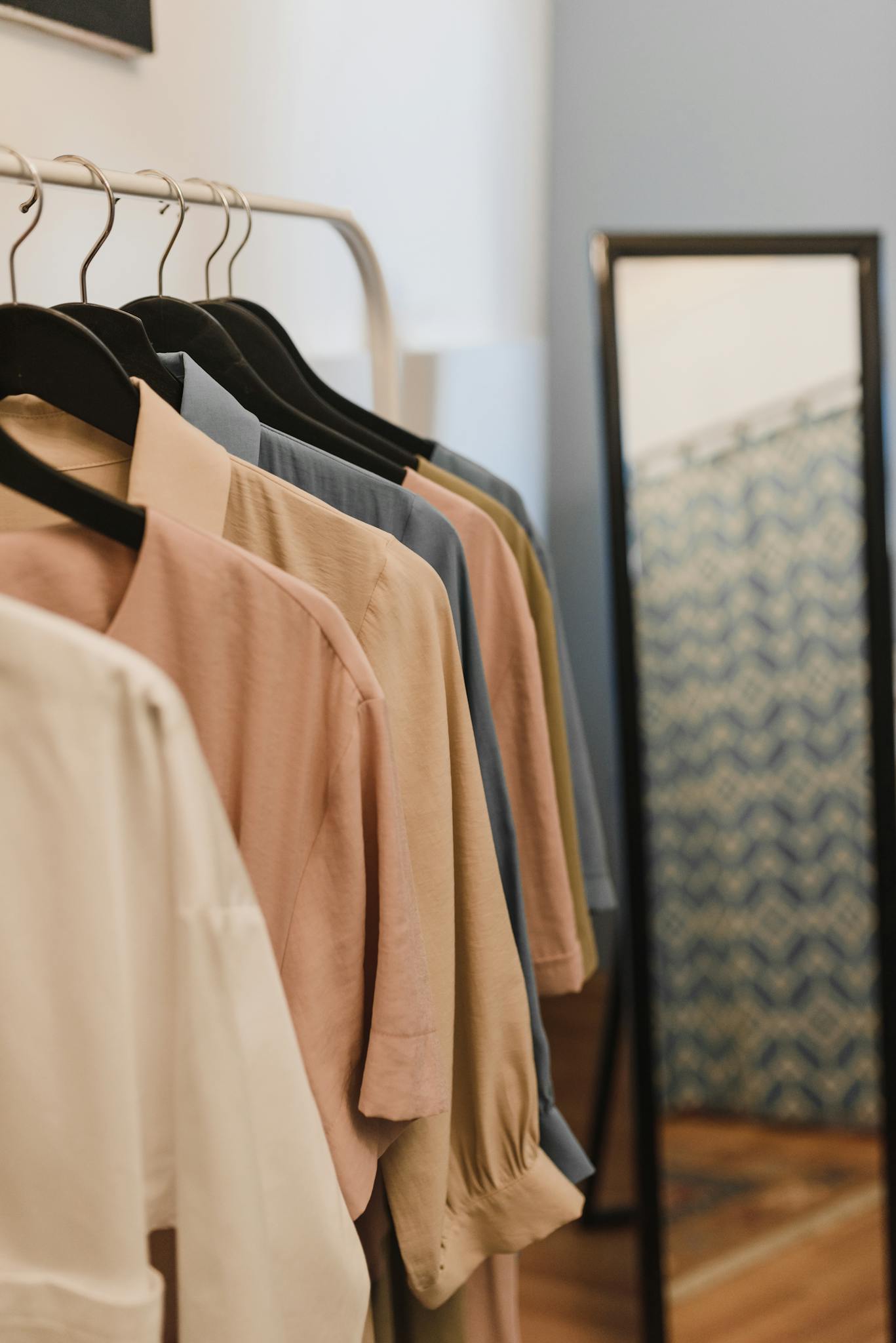 Fashion clothes displayed on hangers with a&nbsp;mirror reflection creating a&nbsp;stylish boutique vibe.
